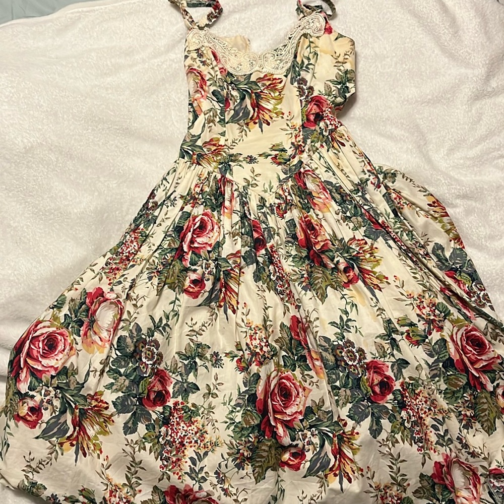 This is a cream floral, midi dress with boning